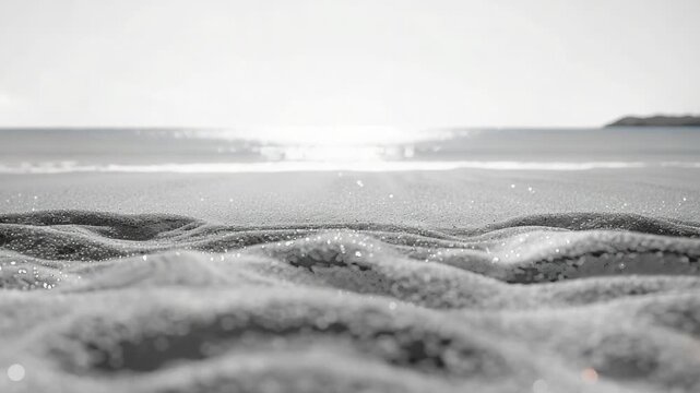 A serene black and white image of a peaceful beach scene with minimalistic waves and shore