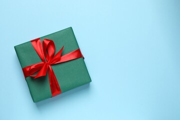 Luxurious gift box with tied ribbon on pastel blue background