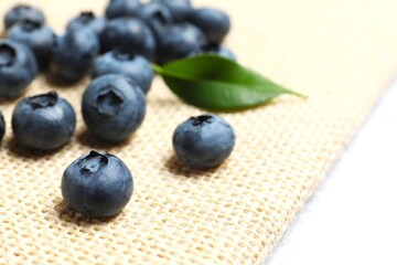 Tasty blueberries on burlap, closeup