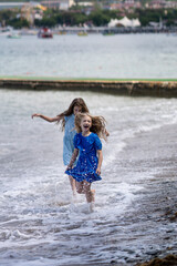 Girls playing with the waves