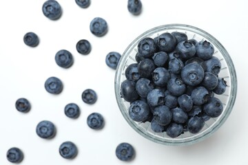 Bowl with fresh blueberries on white background. Top view