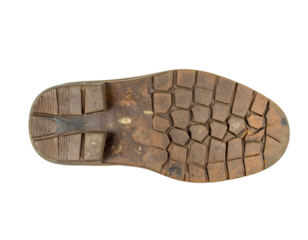 A torn and weathered shoe sole, isolated on a white background, highlighting the issue of waste and the longevity of materials.