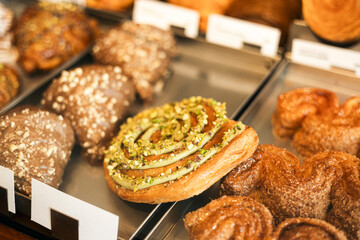 Dubai chocolate cinnamon roll with pistachio frosting and kataifi topping.