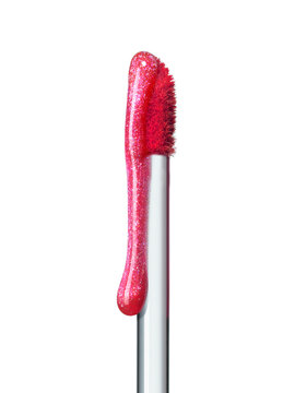 Shimmering pink lip gloss texture dripping down brush isolated on white background. Smudged cosmetic product smear. Makeup swatch product sample