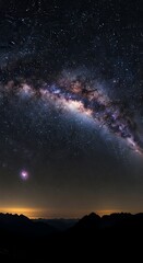 Fototapeta premium Majestic celestial expanse of the Milky Way galaxy over the silhouetted mountain ridge