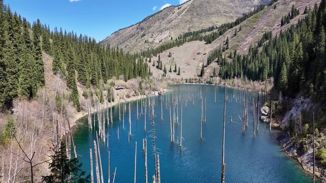 Kolsay lake, Kazakhstan: footage of the famous Kaindy lake in the mountains near Almaty in Central Asia on a sunny spring day.