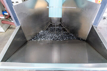 Plastic granules in industrial hopper for manufacturing, recycling, polymer processing and raw material preparation in modern production and chemical engineering solutions.