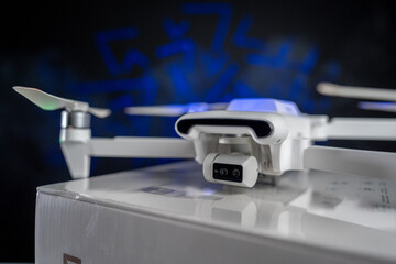 White Flying Drone with Camera on black background 
