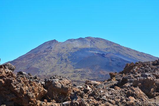 Pico Viejo volcano view through rocks, which is part of the Teide National Park in Tenerife, Canary Islands.