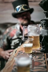 Steampunk Vibes with draft Beer in glass and jar and Skull Decor blur bearded man in the background