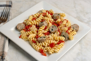 rotini pasta  served with tomatoes and chicken sausage