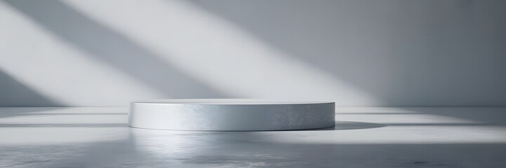 Minimalist Studio with a Round Podium and Dramatic Shadow Play