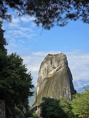 Sky-High Cliffs of Meteora Natural Framed with Pine Trees and Blue Sky
