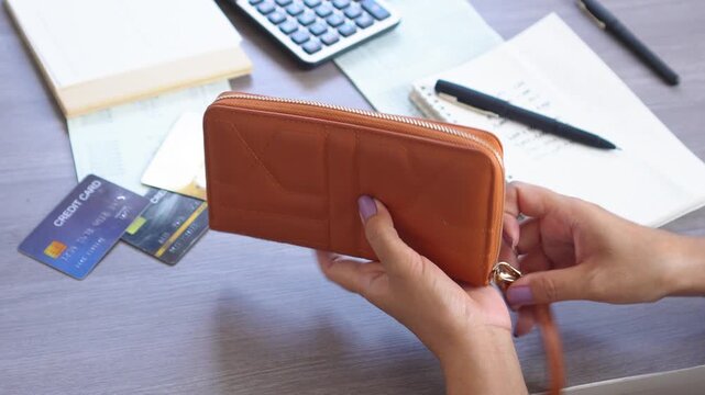 woman opening empty purse and looking for money, struggling with financial problems, bankruptcy, and being broke after credit card payday, calculating expenses with not enough money to pay bills, debt