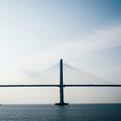 Obraz premium Modern Cable-stayed Bridge Over Calm Water Under Clear Sky