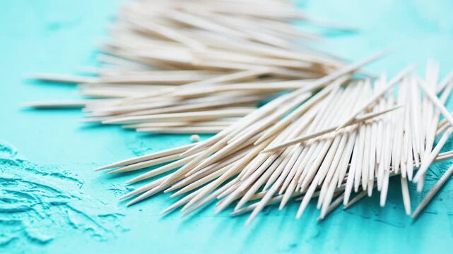 wooden toothpicks on a blue background close-up