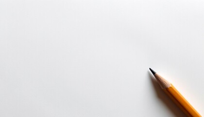 A lone sharpened pencil resting on a blank sheet of paper