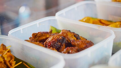 Close-up of traditional Indonesian meal packed in a reusable plastic box