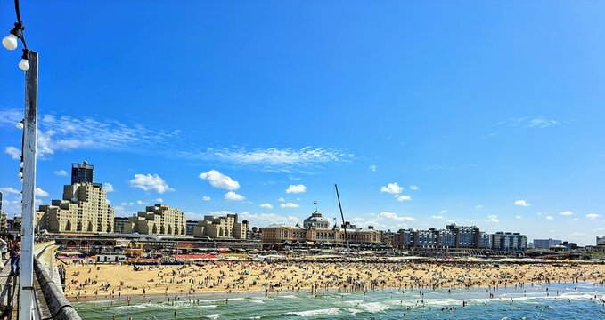 Scheveningen beach promenade in the city of The Hague Holland. Netherlands. Photo taken on August 9, 2025 in sunny summer weather with clear blue sky and white clouds.
