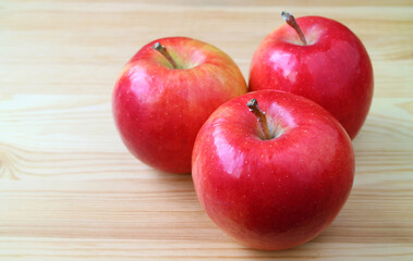 Group of fresh ripe red apple isolated on wooden table	