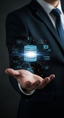A professional in a suit, hand outstretched, supports a digital database with glowing connected elements. The background is dark, implying technology