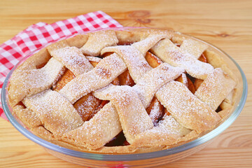 Mouthwatering freshly baked tasty and healthy apple pie on wooden table