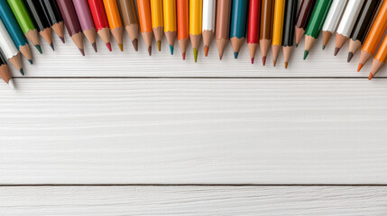 Obraz premium Colorful pencils arranged on white wooden surface create vibrant and artistic display