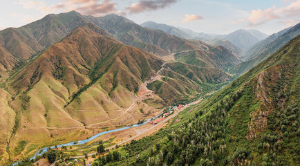 Stunning panoramic view of the mountain range with its colorful slopes and valley during golden...