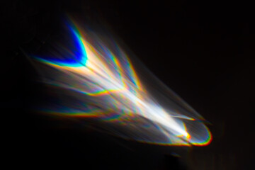 Water texture shadow with rainbow refraction of light on a black backgound. Overlay effect