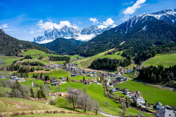 Green meadows and the iconic santa maddalena church create a picturesque scene with the odle mountains in the background