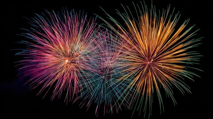 Fototapeta premium Spectacular fireworks display bursts across the night sky, illuminating the darkness with vibrant colors and patterns.