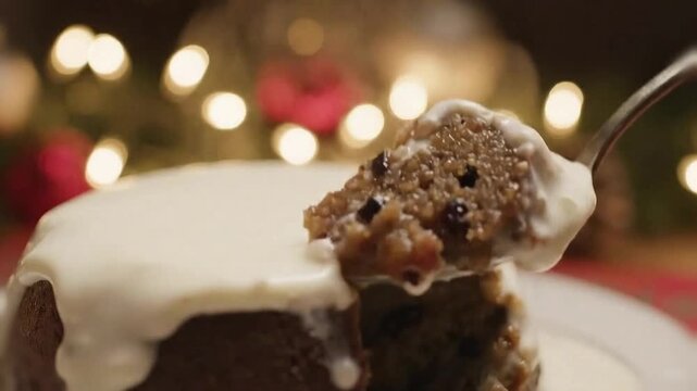 Rich Christmas pudding sliced open and scooped, steam rising while brandy cream melts on top