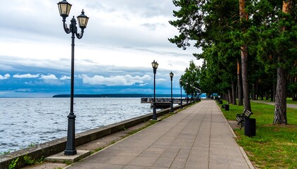 Lakeside walkway under a cloudy sky