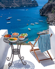 Delicious mediterranean meal served on a balcony overlooking a picturesque coastal village