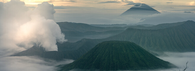 Mount Bromo in the morning amongst clouds. Morning sky