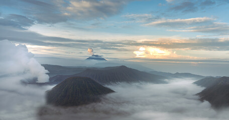 Mount Bromo in the morning amongst clouds. Morning sky