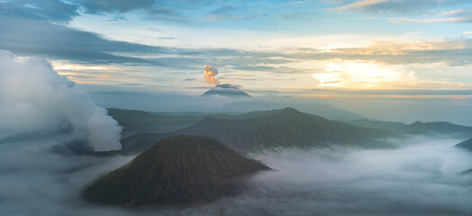 Mount Bromo in the morning amongst clouds. Morning sky