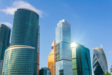 Obraz premium view of modern skyscrapers tops against blue sky