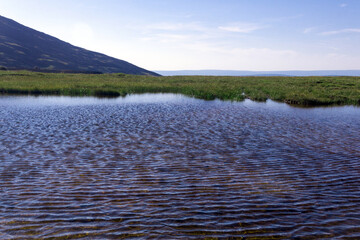 shallow lake on a plateau in the mountain tundra in the Northern Urals
