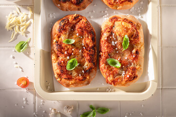 Fresh and tasty pinsa Margherita made of cheese and tomatoes.