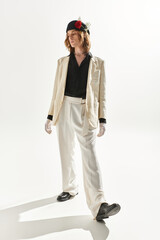 Handsome young man showcases unique fashion sense in stylish outfit against minimalist backdrop