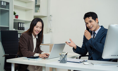 Business team discusses startup strategy with investor using tablet, laptop, and smartphone.