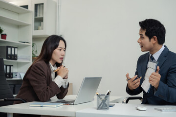 Business team discusses startup strategy with investor using tablet, laptop, and smartphone.