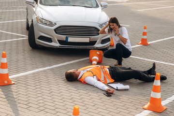 Calling the ambulance. Horrible crash, woman hit a man that is lying down on the road