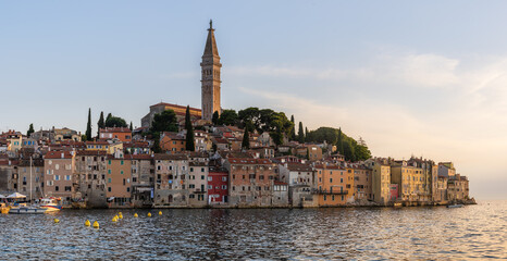 The bell tower of Church of St. Euphemia and the old city of Rovinj, Croatia on a summer day right before the sunset.