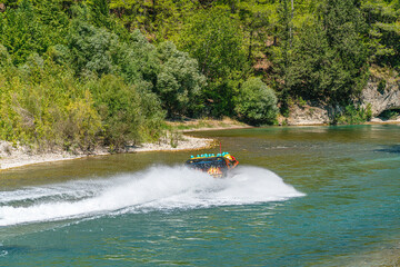 Fototapeta premium The scenic view of enjoying people in the speed boat on the river of Köprüçay, Antalya, Turkey