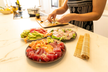 Homemade Sushi Preparation Featuring Fresh Fish sashimi and Avocado Close Up in a Modern Kitchen