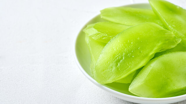 closeup green slice cut wosun or celtuce stem lettuce food white background with copy space