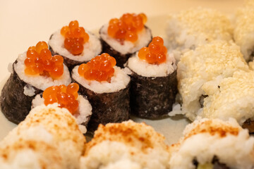 Close-Up of Vibrant Homemade Sushi Rolls with Caviar and Sesame Garnishes
