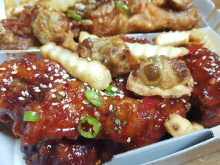 Korean half-and-half chicken topped with dumplings and French fries
